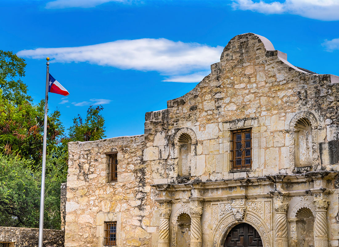 We Are Independent - Historical Building with the Texas Flag Out Front Against a Bright Blue Sky in San Antonio Texas