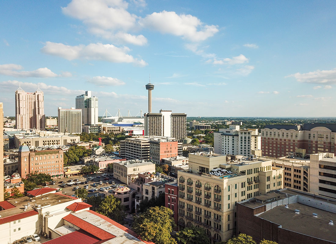 About Our Agency - Aerial View of Modern Commercial Buildings in Downtown San Antonio Texas Against a Cloudy Blue Sky